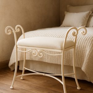 Banqueta de dormitorio Málaga en marfil a los pies de una cama